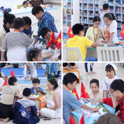Các em nhỏ say sưa tìm hiểu họa tiết trống đồng và chim Lạc cùng ba mẹ trong buổi trải nghiệm Cờ Đông Sơn.