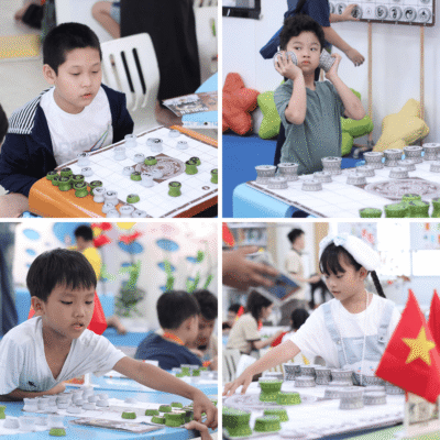 Các em nhỏ tập trung cao độ và có những biểu cảm thú vị khi tham gia trải nghiệm Cờ Đông Sơn.