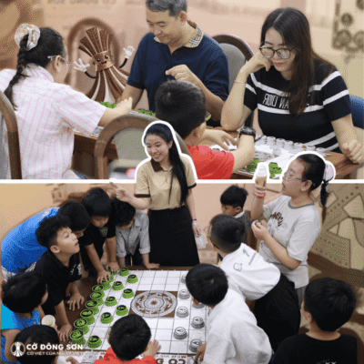 Đội ngũ hướng dẫn viên nhiệt tình chỉ dẫn luật chơi cho các bạn nhỏ tò mò vây quanh bàn cờ lớn trong buổi trải nghiệm Cờ Đông Sơn.